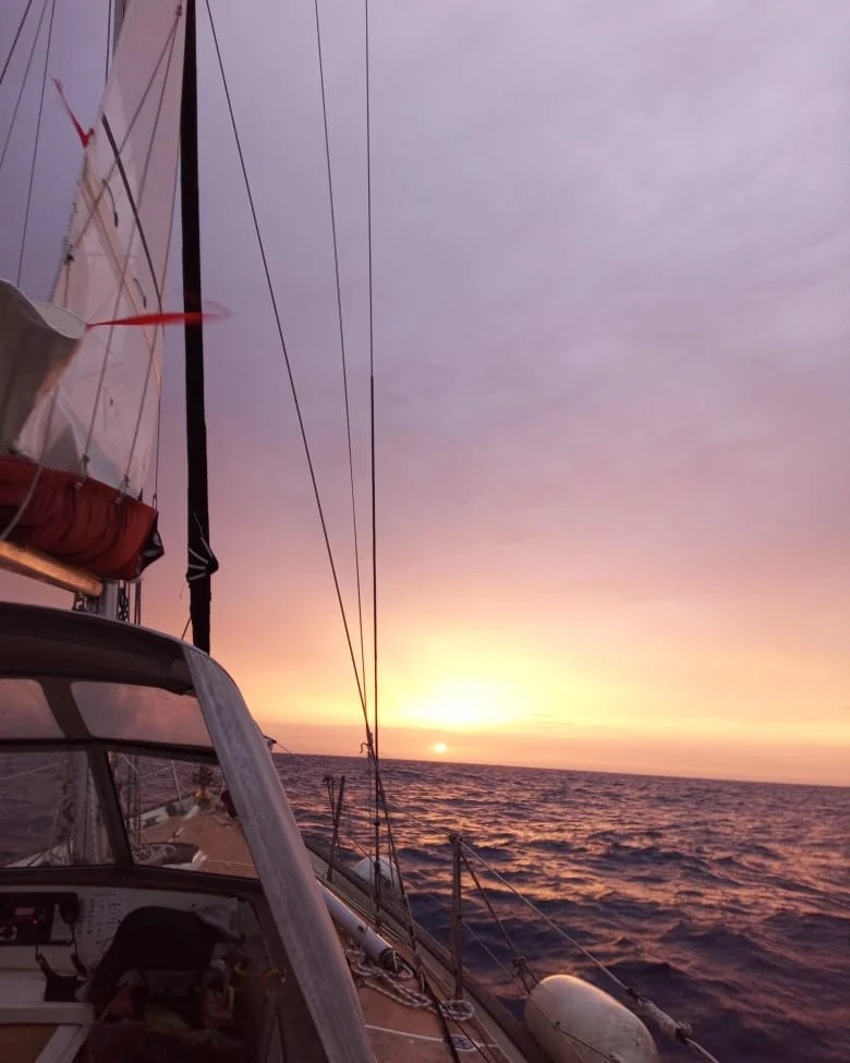 A sailboat sailing into the sunset