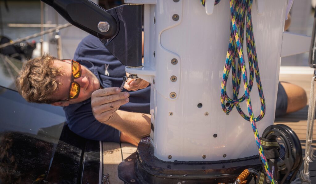 Yacht rigger working on the mast of a sailing yacht